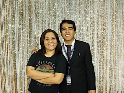 Two school founders posing for a photo in the photo booth.