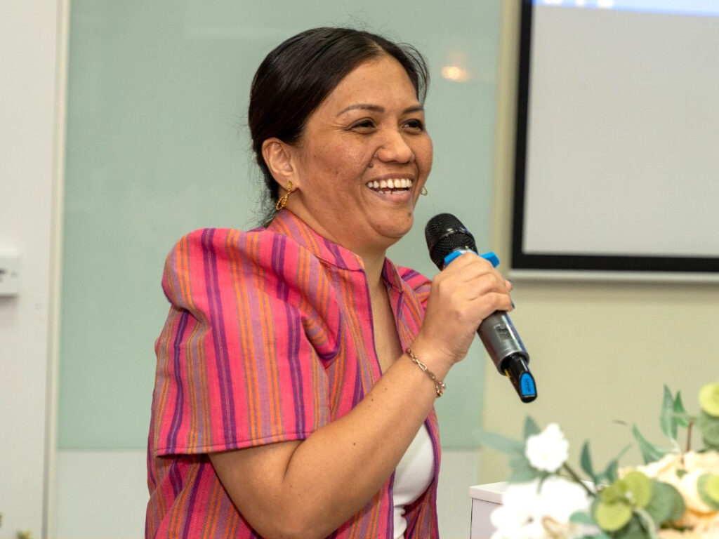 A founder delivering a speech in front of the audience.