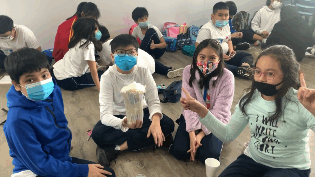 A group of singapore international students wearing facemasks while posing for a group photo.
