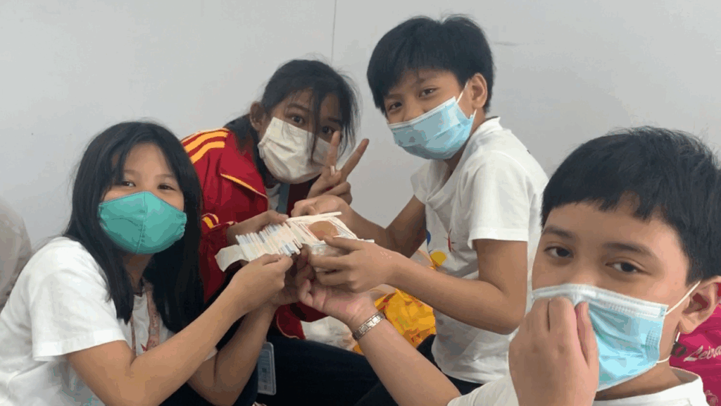 A group of students singapore international wearing facemasks while posing for a group photo.