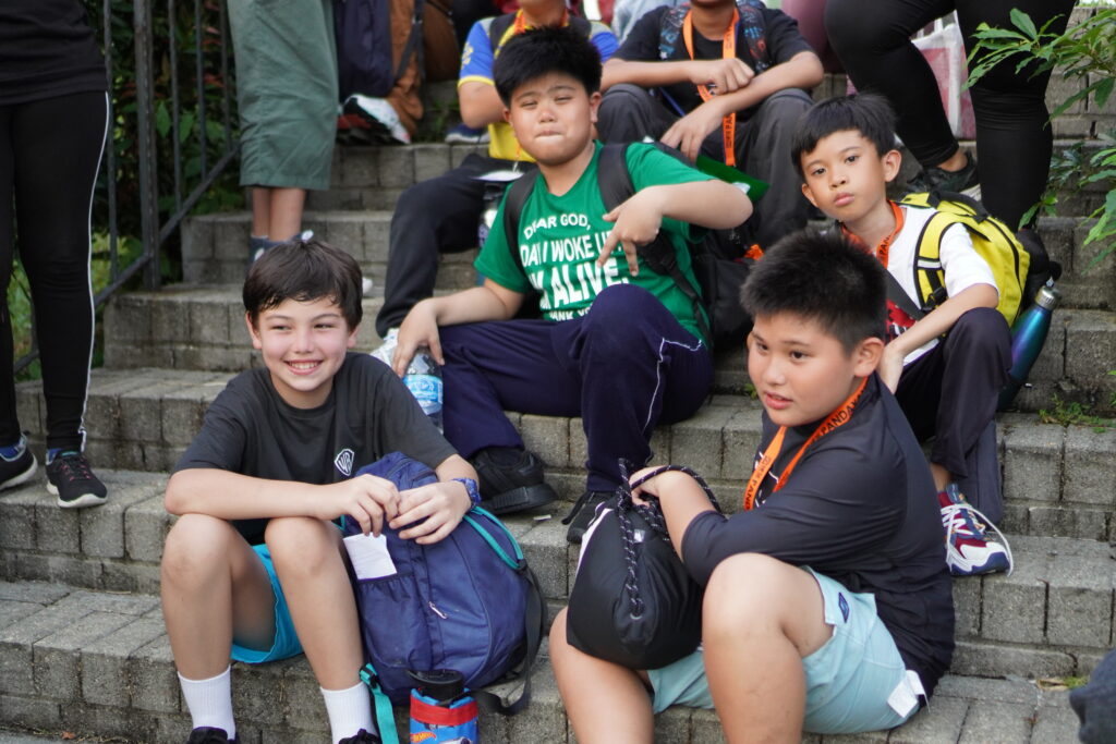 International students in Singapore smiling and posing together for a group photo.